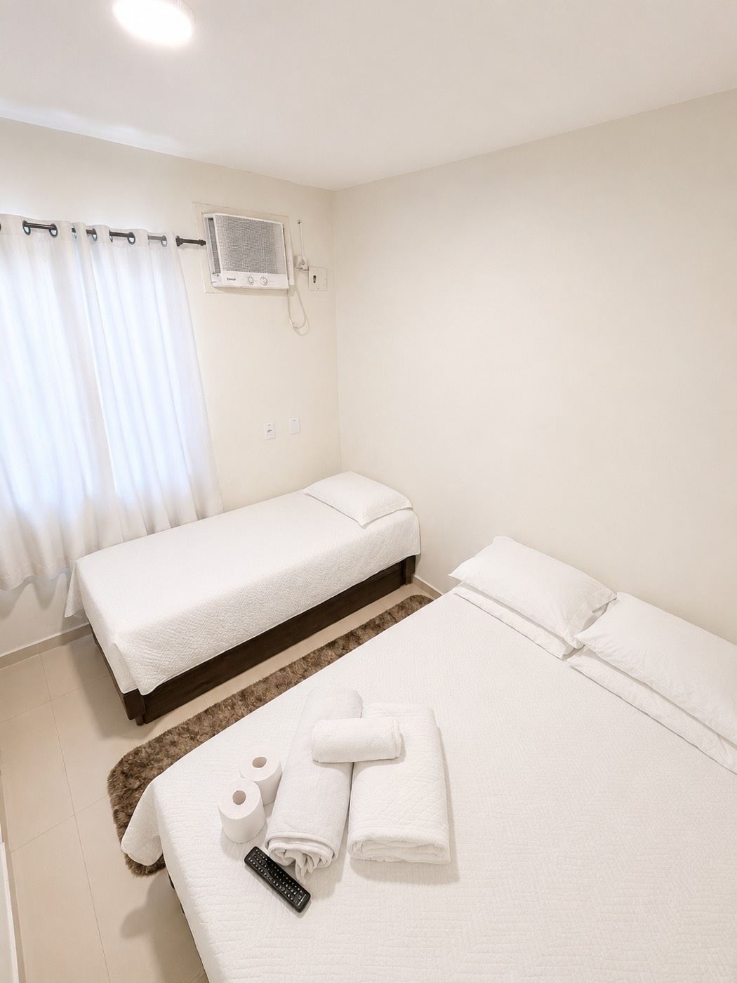 Quarto com cama de casal e cama de solteiro em apartamento da Rua Pedro Alves